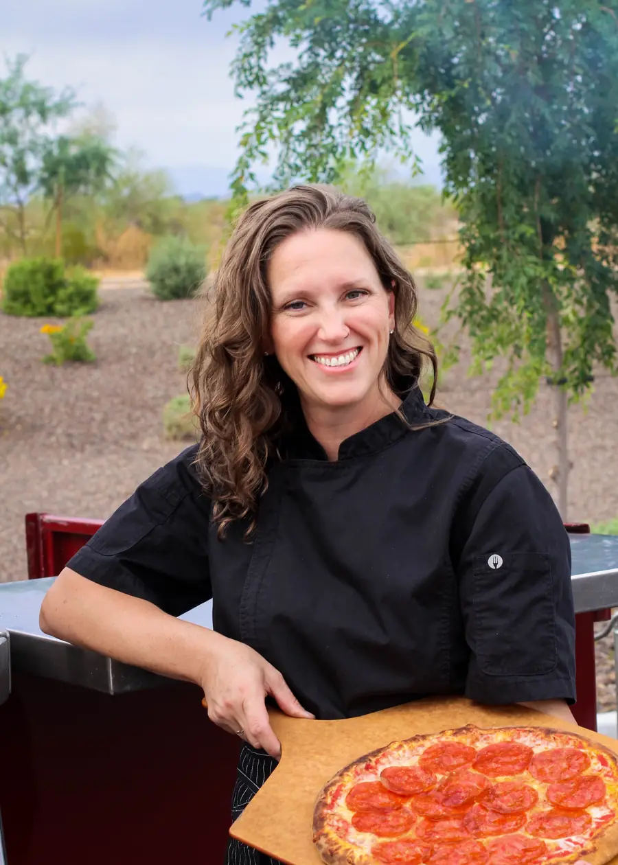 Local Hive chef serving a fresh pizza